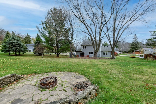 view of yard with an outdoor fire pit and a patio area