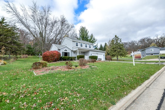 view of front property featuring a front lawn and a garage