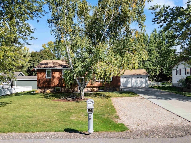 view of front of home featuring a front yard and a garage