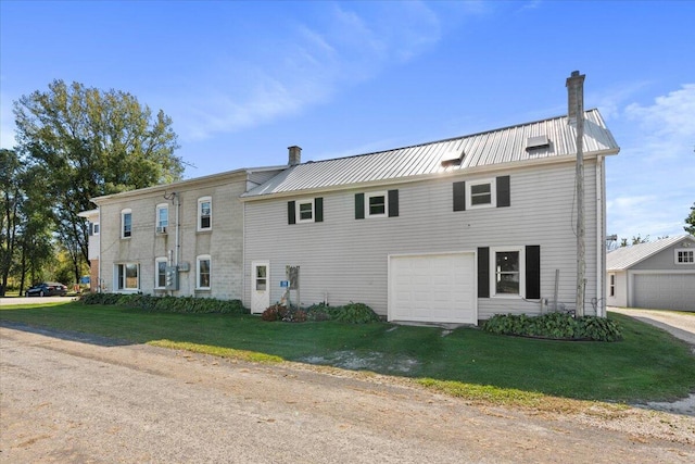 view of front of house with a front lawn and a garage