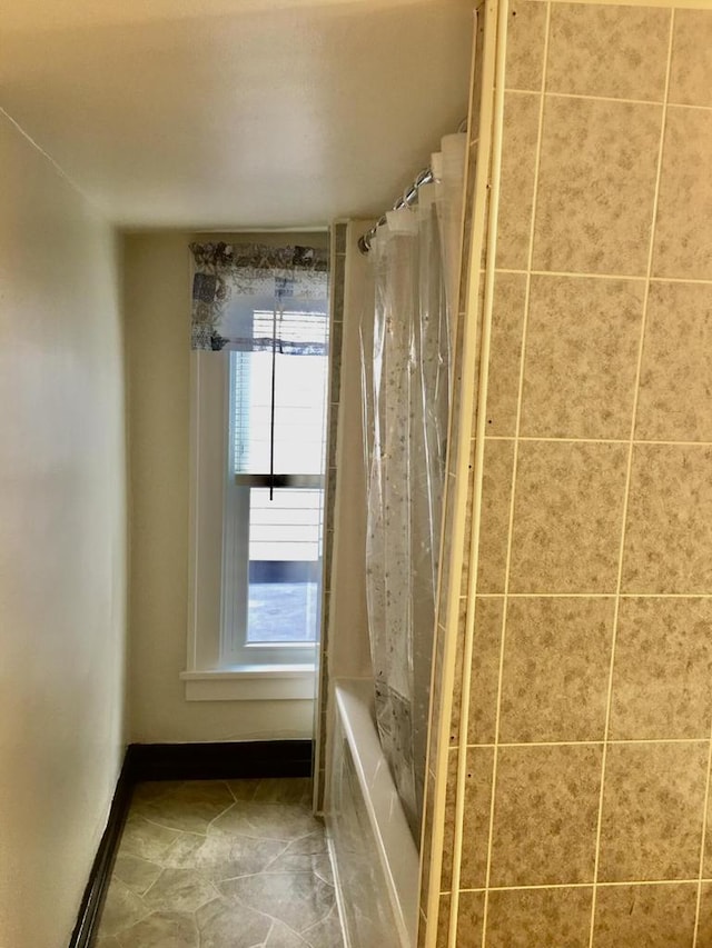 bathroom with shower / tub combo with curtain