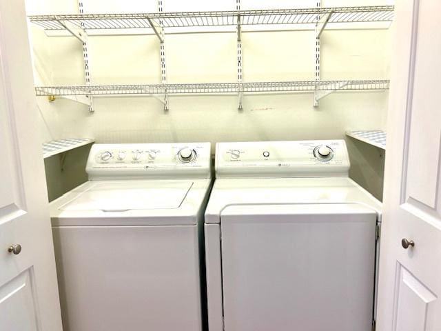 clothes washing area featuring washer and clothes dryer