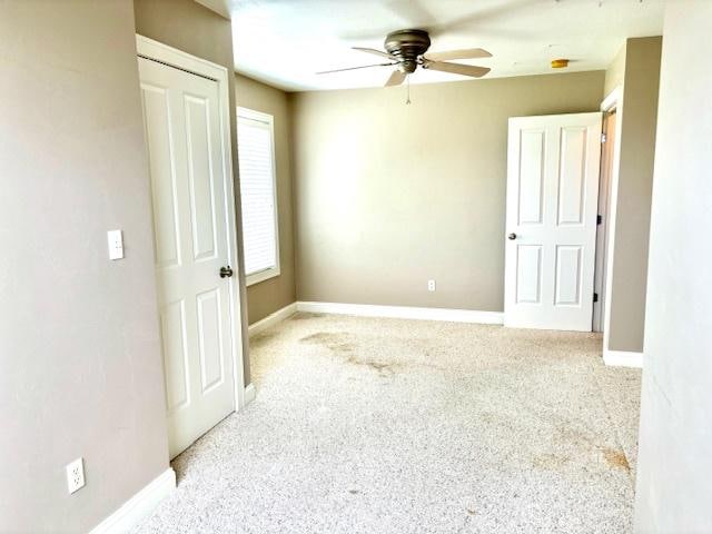 unfurnished bedroom featuring ceiling fan and light carpet