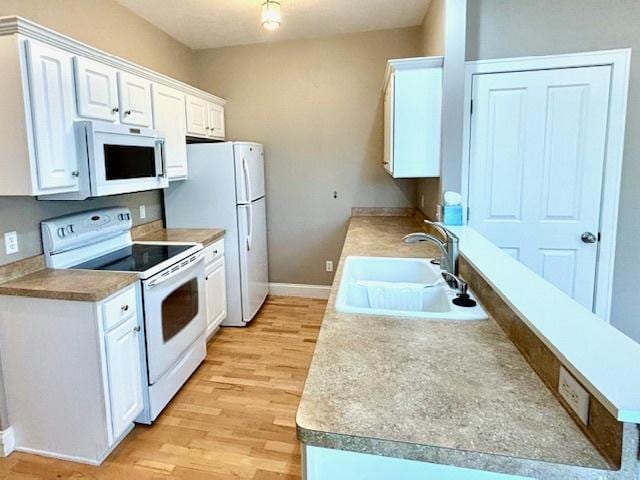 kitchen with white cabinetry, light wood-type flooring, white appliances, and sink