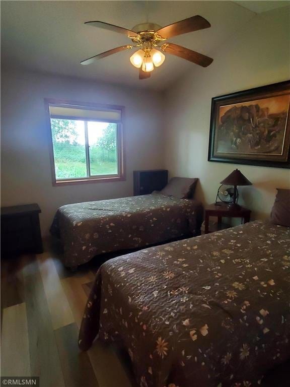 bedroom with wood-type flooring and ceiling fan