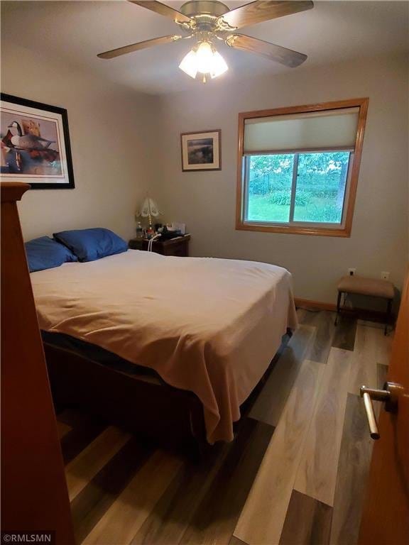 bedroom with light wood-type flooring and ceiling fan