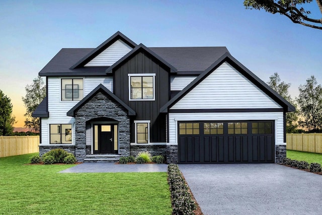 view of front of home featuring a garage and a yard