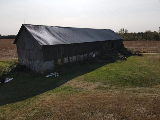 view of outbuilding featuring a lawn