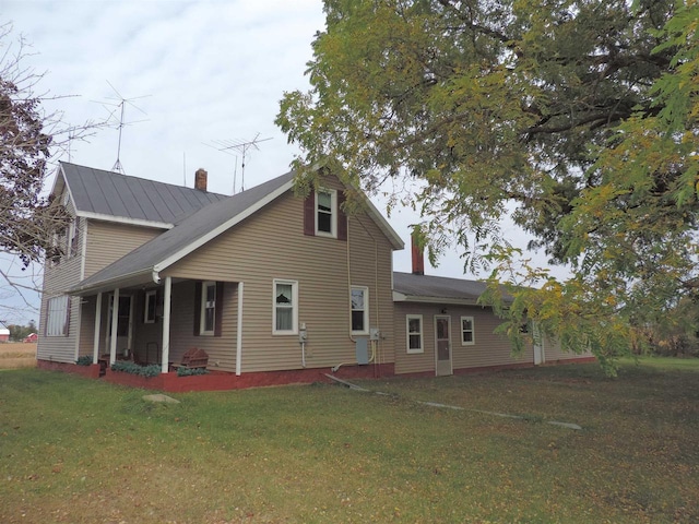 rear view of property with a lawn