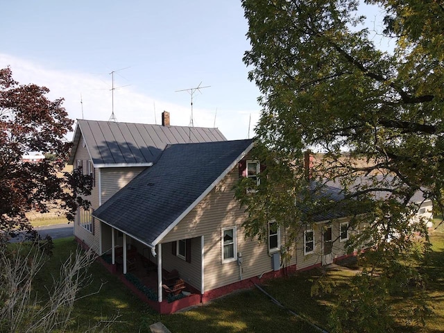 view of side of home with a yard