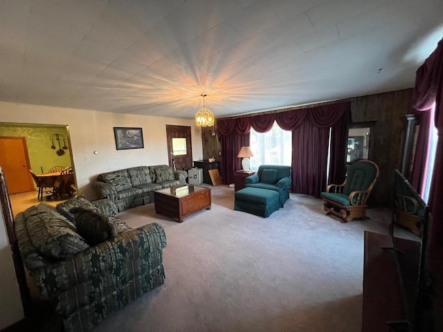 living room with carpet floors and a notable chandelier