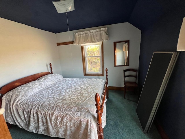 bedroom with dark colored carpet and vaulted ceiling