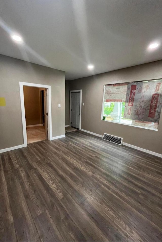 unfurnished living room featuring dark hardwood / wood-style floors