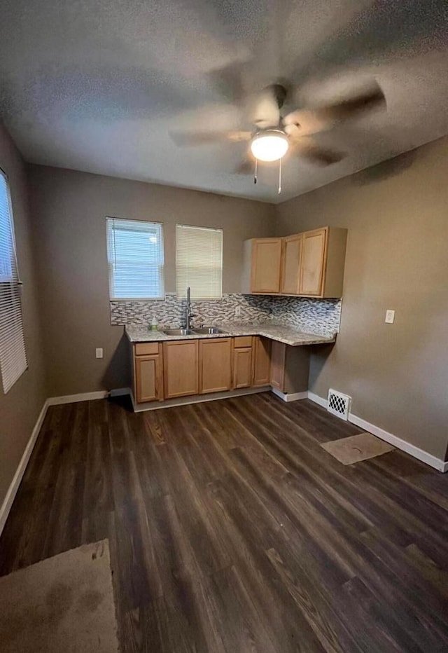 kitchen with dark wood-type flooring, backsplash, a textured ceiling, ceiling fan, and sink