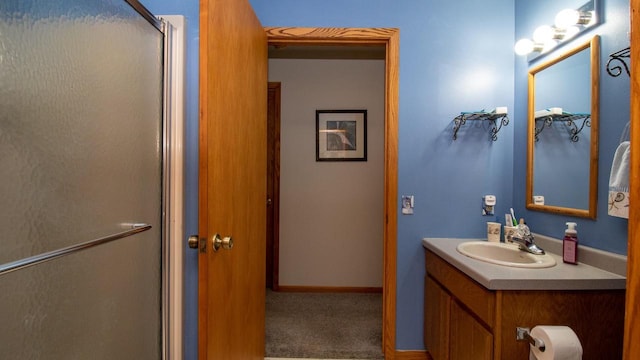 bathroom with vanity and a shower with shower door