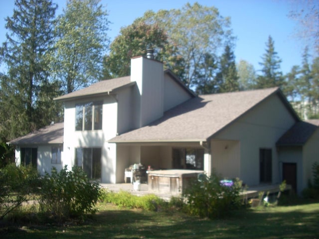 rear view of property with a lawn and a patio area