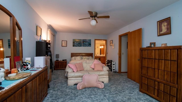 bedroom with dark colored carpet, ensuite bath, and ceiling fan