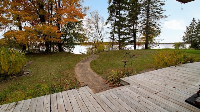 exterior space featuring a yard and a deck with water view