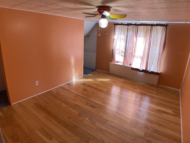 unfurnished room featuring ceiling fan and hardwood / wood-style flooring