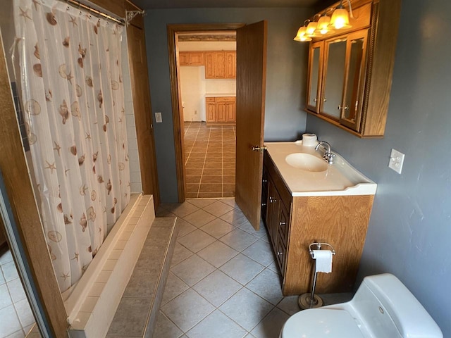 bathroom featuring tile patterned flooring, walk in shower, vanity, and toilet