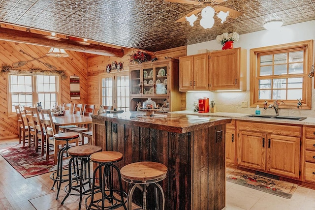 kitchen featuring wooden walls, a wealth of natural light, and light wood-type flooring