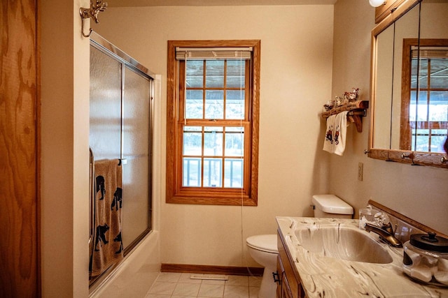 full bathroom featuring enclosed tub / shower combo, vanity, toilet, and tile patterned floors