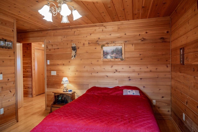 bedroom with hardwood / wood-style flooring, wooden walls, and wood ceiling