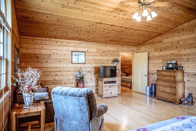 living room with wood ceiling, vaulted ceiling, light hardwood / wood-style flooring, wooden walls, and ceiling fan