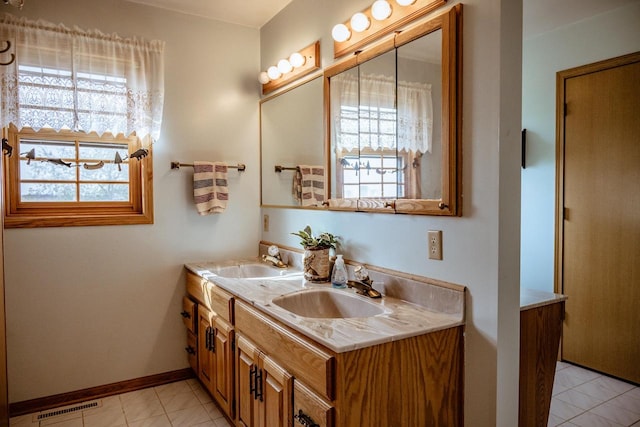 bathroom with tile patterned flooring and vanity