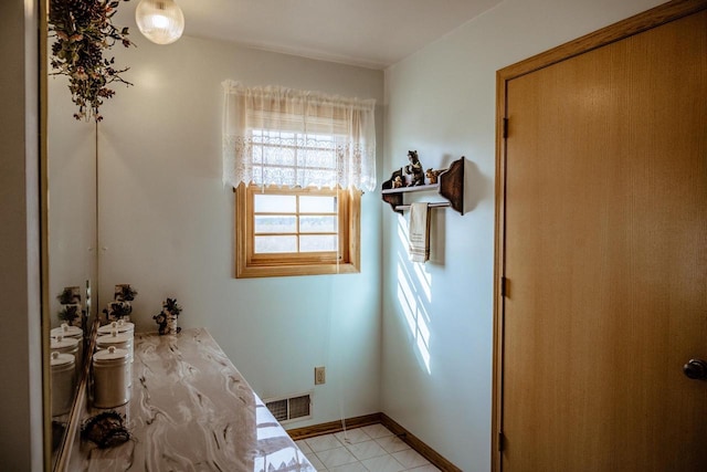 bathroom with tile patterned floors