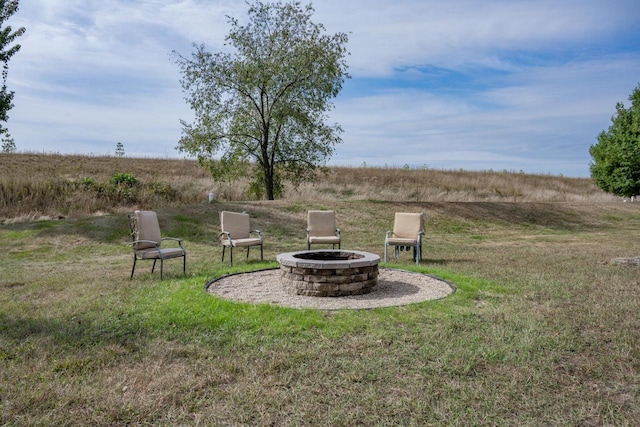 view of yard with a rural view and a fire pit