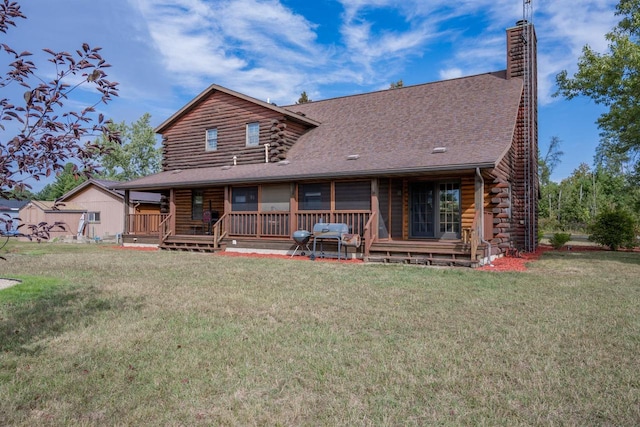 rear view of house featuring a lawn