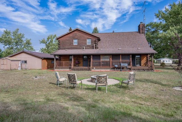 back of property with a lawn and a wooden deck