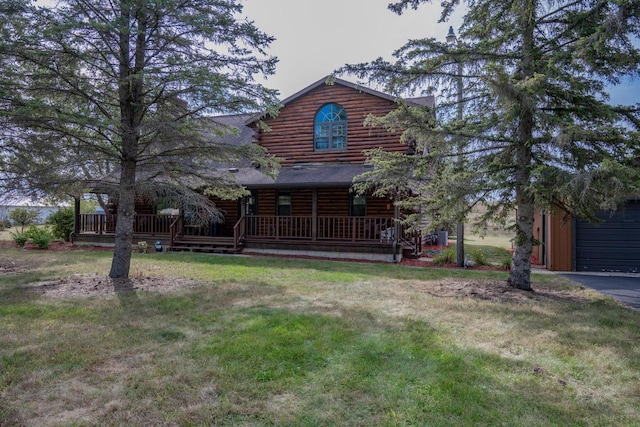 view of front facade featuring covered porch, a front yard, and a garage