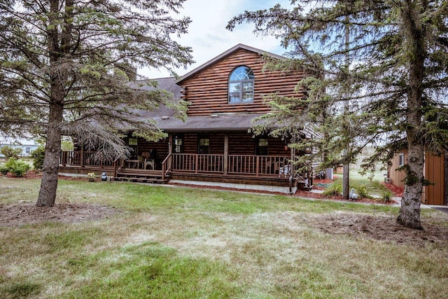 rear view of property with a lawn