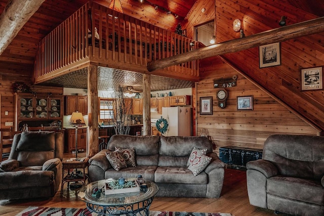 living room featuring high vaulted ceiling, wood walls, beamed ceiling, wooden ceiling, and wood-type flooring