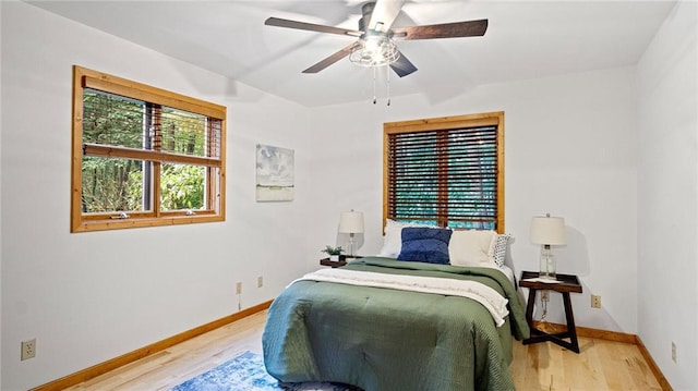 bedroom with light hardwood / wood-style floors and ceiling fan