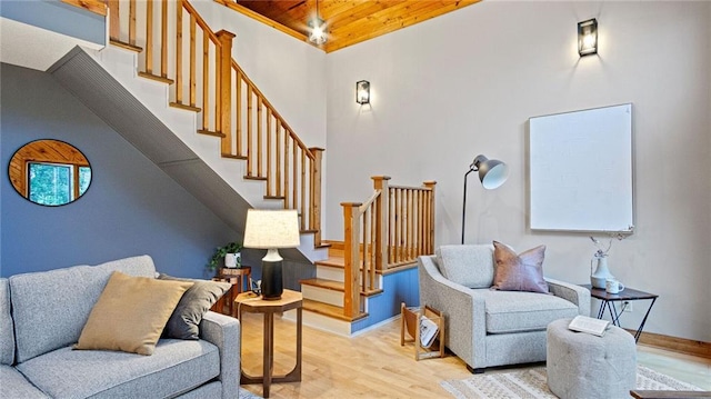 living room with light hardwood / wood-style floors and wood ceiling