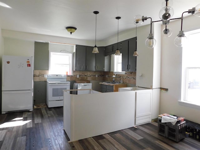 kitchen with white appliances, gray cabinetry, decorative light fixtures, backsplash, and dark wood-type flooring