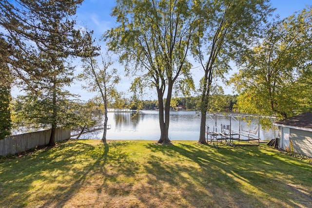 view of yard with a boat dock and a water view