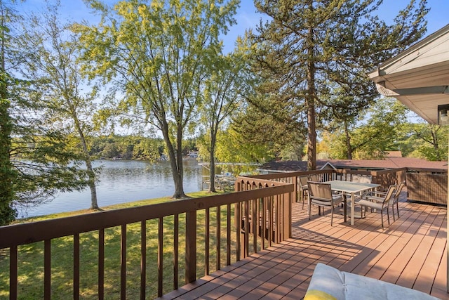 wooden terrace featuring a water view