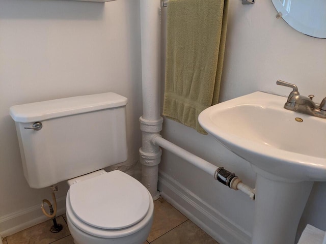 bathroom featuring tile patterned flooring, toilet, and sink