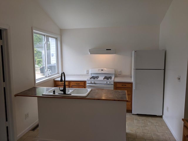 kitchen featuring white appliances, exhaust hood, sink, vaulted ceiling, and light tile patterned flooring