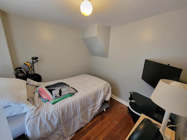 bedroom with dark hardwood / wood-style flooring