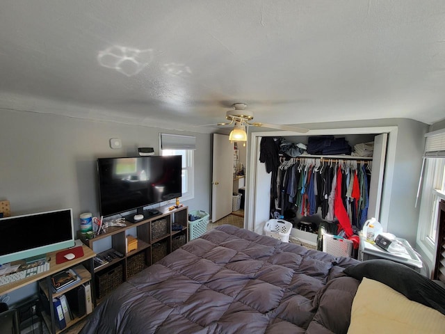 bedroom with ceiling fan and a closet