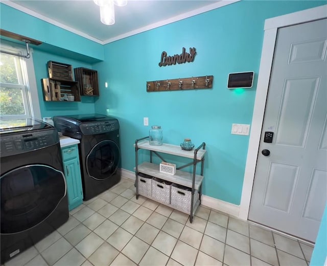 laundry area featuring washing machine and clothes dryer, cabinets, ornamental molding, and light tile patterned floors