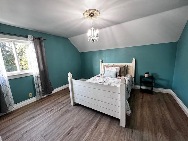 bedroom featuring a notable chandelier, vaulted ceiling, and wood-type flooring