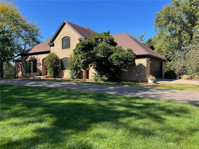 french country inspired facade with a garage and a front lawn