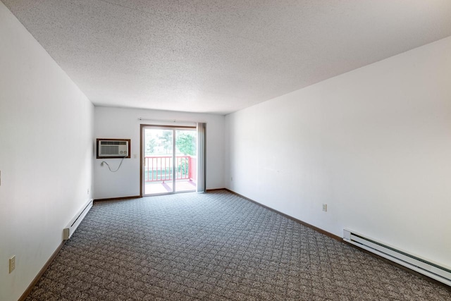 carpeted spare room featuring a textured ceiling, a baseboard heating unit, and a wall mounted air conditioner