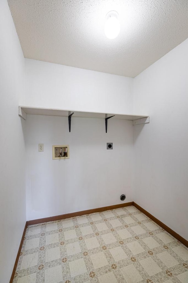 laundry area with hookup for a washing machine, a textured ceiling, and hookup for an electric dryer